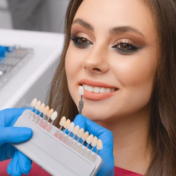 A woman sitting in a dentist's chair.